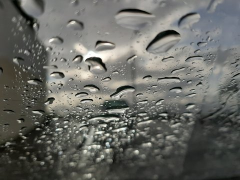 Images of the fall: car windshield with rain drops viewed from car interior