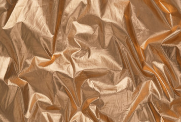 Trendy holographic golden foil background. Bright gold textile backdrop. Luxury minimal concept....