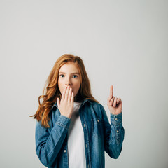 The red-haired girl in surprise points to a place for an inscription. She seems to have a wonderful idea. She covered her mouth from surprise