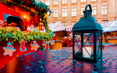 Street lamp with candles at Christmas Market at Riga in Winter Latvia. Light lantern on Advent Fair...