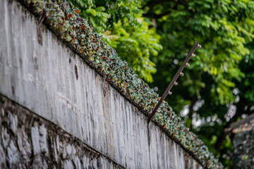 Smashed glass bottles are stuck on the top of a wall to prevent prisoners escaping from the Hanoi...