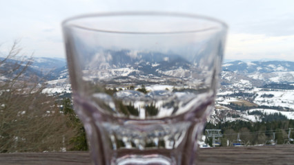 transparent glass on a snowy mountain landscape