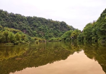 Fototapeta premium a beatiful lake with green trees and reflection in the water