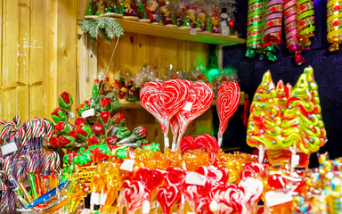 Lollipop candies in Christmas market in Lithuania Europe in winter. Sweet food at Lithuanian Night street Xmas and holiday fair European city or town, December. Vilnius