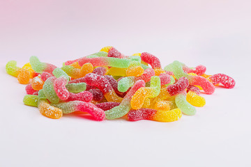 Colorful sweet jelly candies on pink background background. Background with sweet motif.
