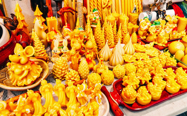 Wax candles at Christmas Market at Gendarmenmarkt square in Winter Riga, Latvia. Advent Fair Decoration and Stalls with Crafts Items on the Bazaar. Latvian street Xmas and holiday in European city