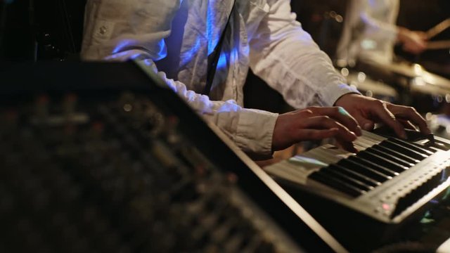 Musician using an electronic keyboard and guitar