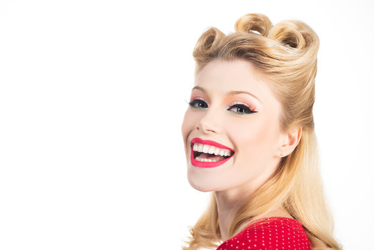 Portrait smile blond woman in pinup style. Isolated over white color background. Attractive woman in red dress retro hairdo.