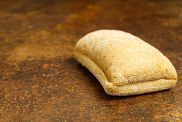 Italian ciabatta on a brown table with a rusty texture