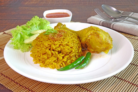 Biryani rice with chicken drumstick. Biryani, also known as biriyani, biriani, birani or briyani, is a mixed rice dish with its origins among the Muslims of the Indian subcontinent. Halal food.