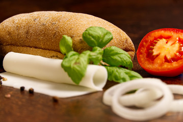 Italian ciabatta and sandwich ingredients. onion, tomato, pepper, goat cheese, razmoin, basil and avocado. Photo