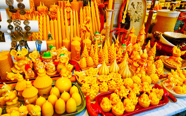 Wax candles at Christmas Market at Gendarmenmarkt square in Winter Riga, Latvia. Advent Fair Decoration and Stalls with Crafts Items on the Bazaar. Latvian street Xmas and holiday in European city