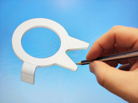 The mans hand holds a pencil pointing to the 3D model of the fastener shown on the monitor. The use of computer-aided design systems.