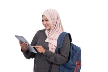 College student using tablet to study and carrying a bag at isolated background