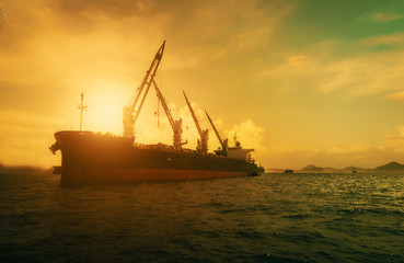 Fototapeta premium Silhouette Logistics and transportation of International Container Cargo ship in the ocean at Sunshine sky, Freight Transportation, Shipping