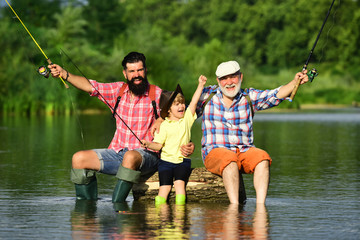Hobby and sport activity. Happy people family have fishing and fun together. Dad and son fishing at...
