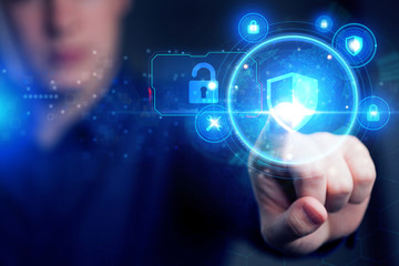 Cyber security data protection business technology privacy concept. Young businessman working  in the office, select the icon security on the virtual display.