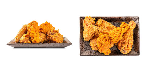 Set of fries chicken on black plate on white background.