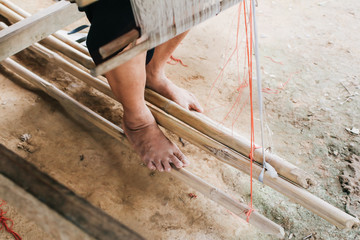 Weaving equipment Household weaving - Detail of weaving loom for homemade silk Used for silk weaving or textile production of Thailand Native cotton weaving using a Loom of weaving, which is folk wisd