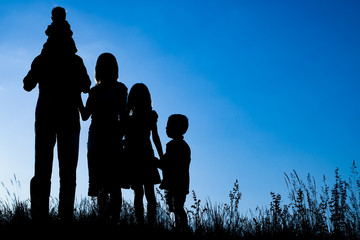 happy family outdoors in the park silhouette