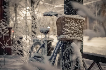 Bicycle covered with snow in winter