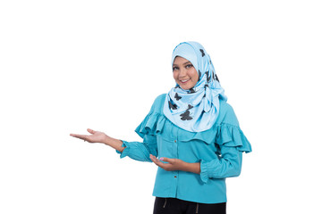 Beautiful veiled woman standing with hands gesture holding something with isolated background