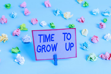 Conceptual hand writing showing Time To Grow Up. Concept meaning knowing that you are mature demonstrating have responsibility Colored crumpled papers empty reminder blue floor clothespin