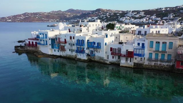 Aerial drone bird's eye view video of iconic little Venice near church of Paraportiani in main village of Mykonos island, Cyclades, Greece