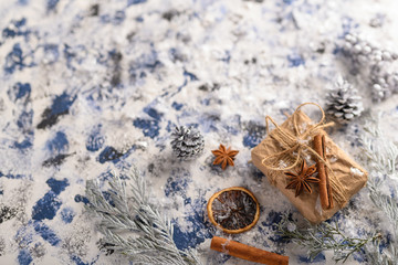 Christmas composition. Gift, cones from the Christmas tree and Christmas tree branches. Background for New Year and Christmas.