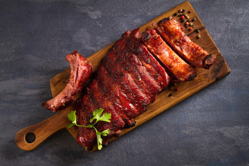 Pork loin ribs served on chopping board. View from above, top - obrazy, fototapety, plakaty