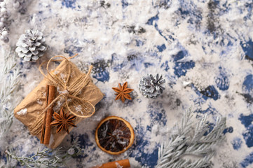 Christmas composition. Gift, cones from the Christmas tree and Christmas tree branches. Background for New Year and Christmas.