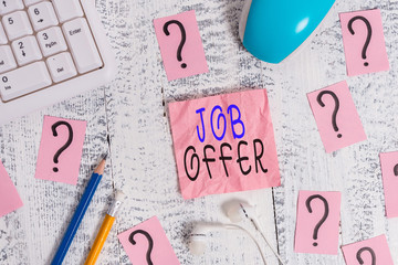 Conceptual hand writing showing Job Offer. Concept meaning Demonstrating or company that gives opurtunity for one employment Writing tools and scribbled paper on top of the wooden table