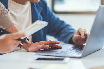 Businessman discussing and  working on laptop computer together in office