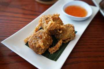 Close up deep fried crab meat rolls on wooden table