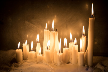 Candles in night in christmas mood on vintage wooden boards