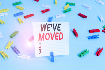 Word writing text We Ve Moved. Business photo showcasing To go from one residence or location to another Relocate Colored clothespin papers empty reminder blue floor background office pin