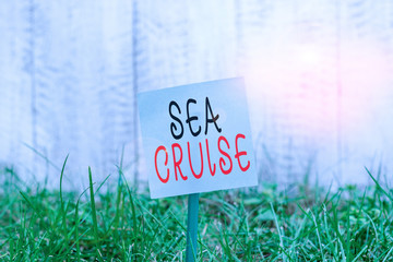 Text sign showing Sea Cruise. Business photo showcasing a voyage on a ship or boat taken for pleasure or as a vacation Plain empty paper attached to a stick and placed in the green grassy land