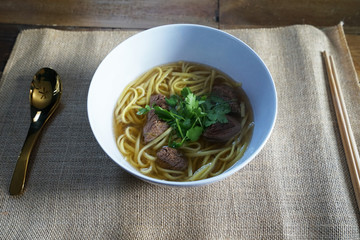 Close up egg noodle with beef stew soup