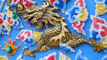 Fototapeta na wymiar Chinese dragon golden on the wall