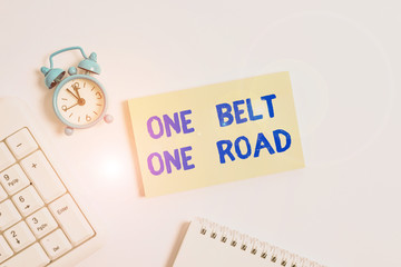 Conceptual hand writing showing One Belt One Road. Concept meaning Building trade routes between China and other countries Keyboard with empty note paper and pencil white background