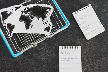 global business goals, world map and shopping basket with Conquer Global Markets to do list
