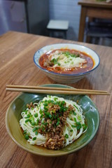 Sichuan style spicy noodles with pork intestines and Zhajiang mian(soybean paste noodle) as...