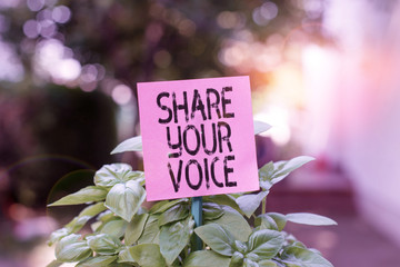 Text sign showing Share Your Voice. Business photo showcasing asking employee or member to give his opinion or suggestion Plain empty paper attached to a stick and placed in the green leafy plants