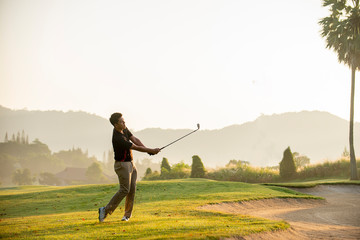 golfer  playing  golf  at  golf  course - obrazy, fototapety, plakaty