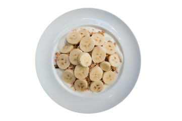 homemade muesli with bananas on white dish