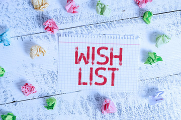 Handwriting text writing Wish List. Conceptual photo List of desired but often realistically unobtainable items Crumpled colored rectangle square shaped paper reminder white wood desk
