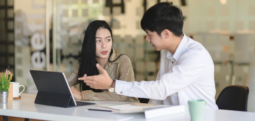 Close-up view of young successful designer team planing their project together