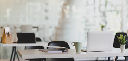 Cropped shot of comfortable workplace with laptop computer and office supplies