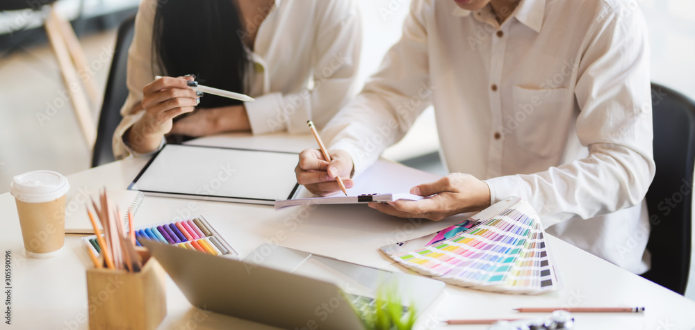 Canvas Prints cropped shot of young professional designer team working on their project while using digital tablet