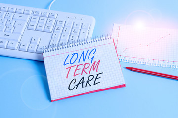 Text sign showing Long Term Care. Business photo showcasing Adult medical nursing Healthcare Elderly Retirement housing Paper blue desk computer keyboard office study notebook chart numbers memo